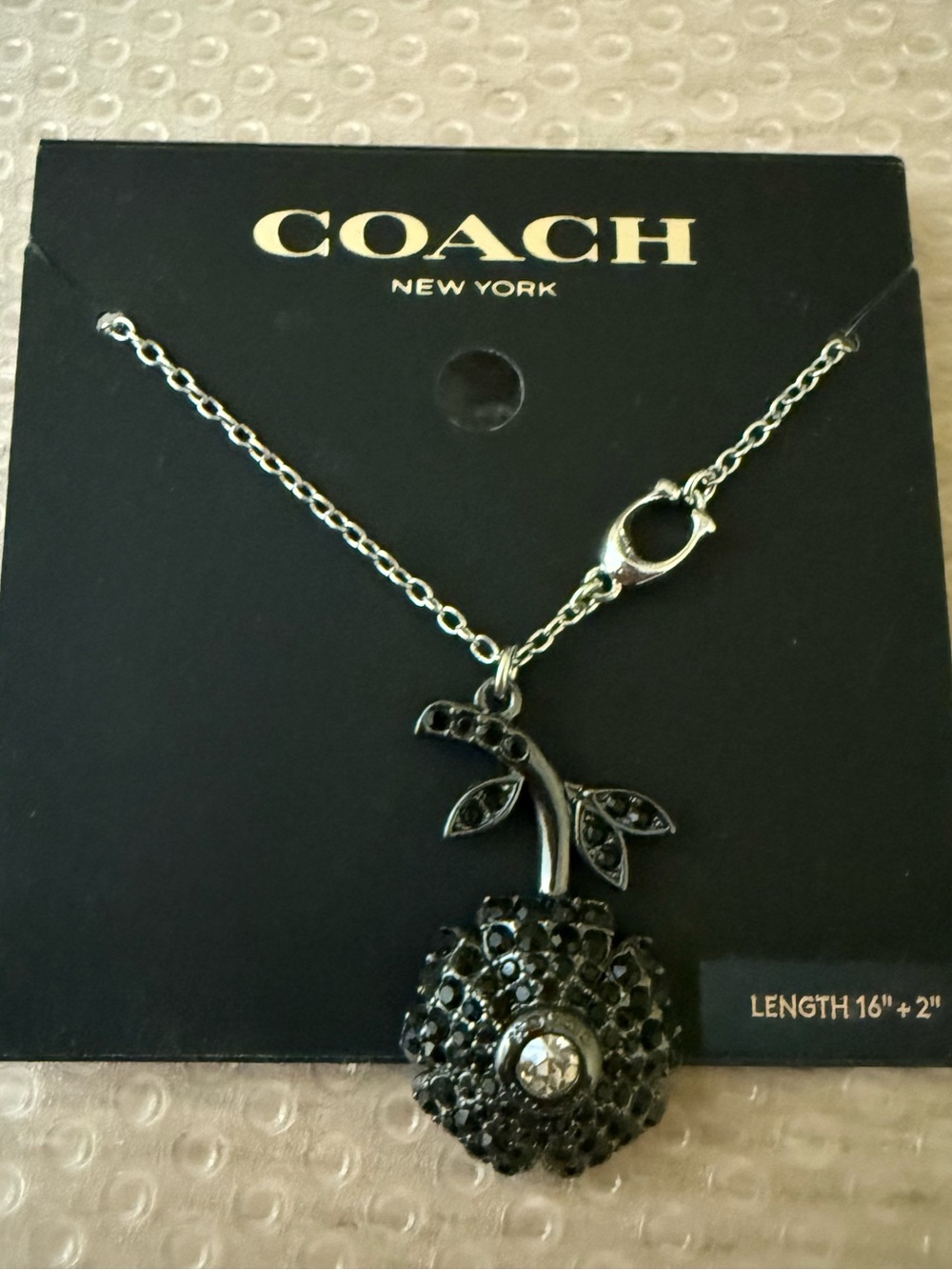 COACH Silver-Tone Black Crystal Flower Pendant Necklace